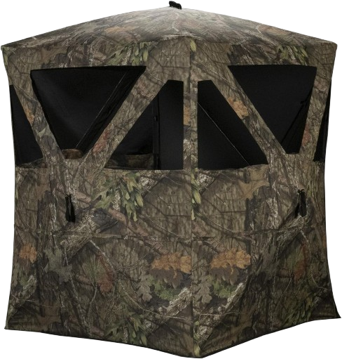 A hunting ground blind set up in a natural outdoor setting, blending with the surrounding foliage. The blind is camouflaged and designed for stealth, providing cover for hunters while they wait for game.